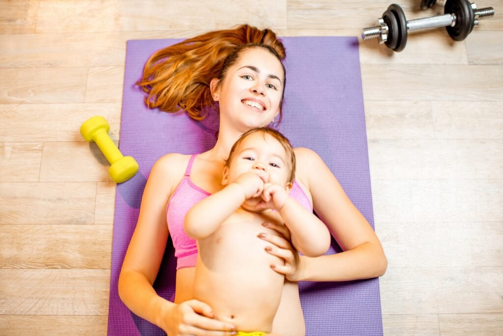 Mother with baby boy exercising on the floor